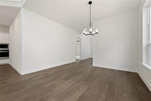 Interior area featuring wood-finish flooring, a contemporary multi-light chandelier, and large window