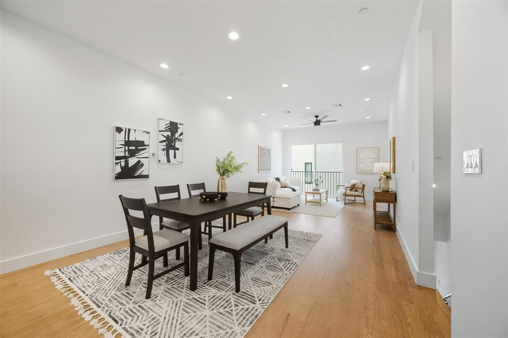 Open-concept interior featuring light-toned wood-finish flooring, recessed lighting, and a ceiling fan