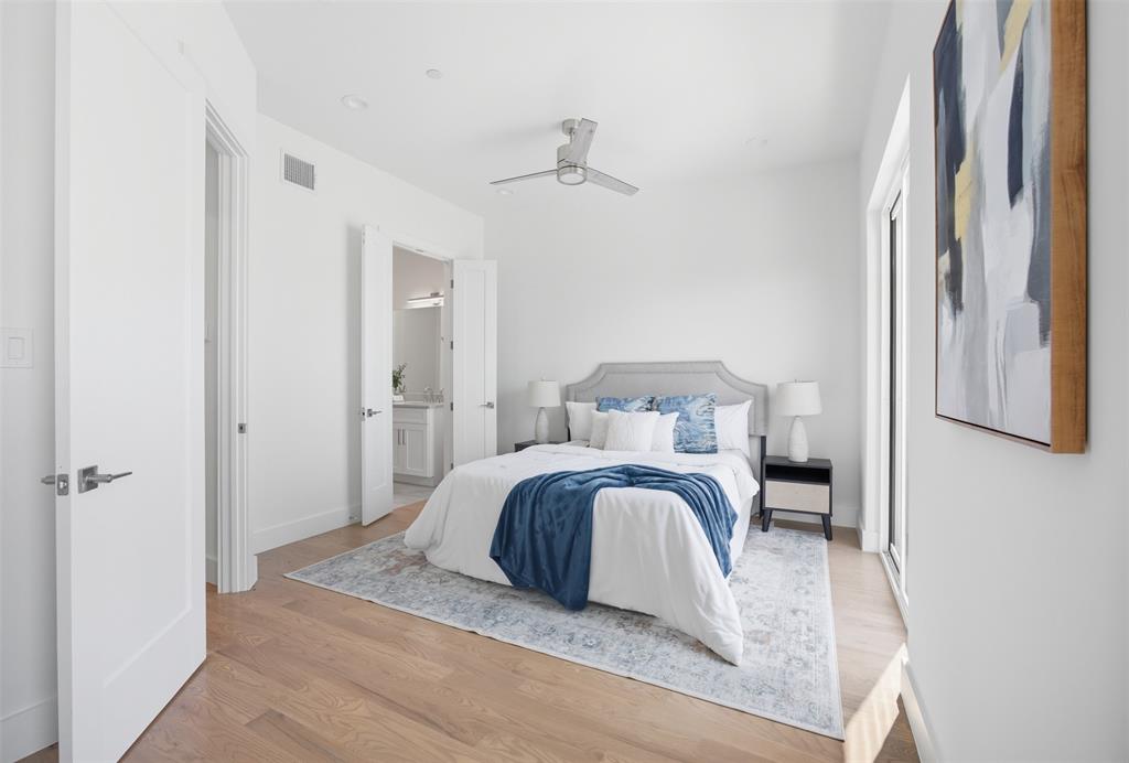 Light-filled room featuring wood-finish flooring, recessed lighting, and a brushed-nickel ceiling fan