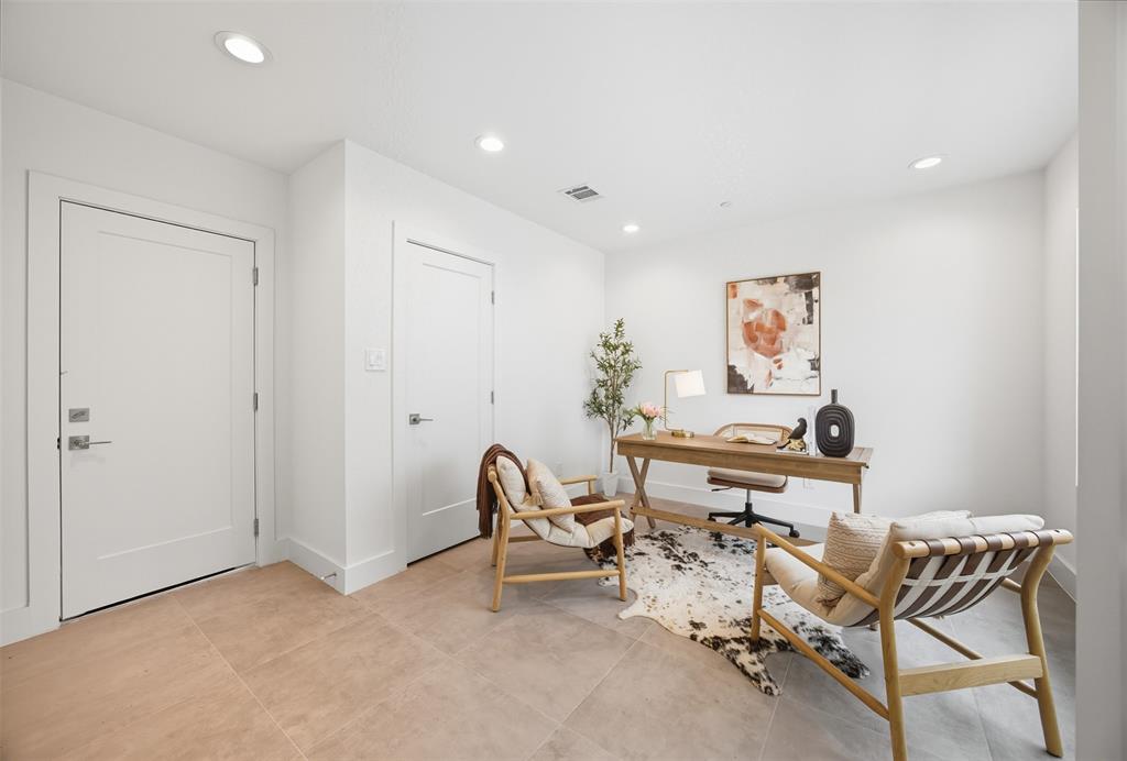Neutral-toned tile flooring, recessed ceiling lighting, and solid-core interior doors with satin nickel hardware