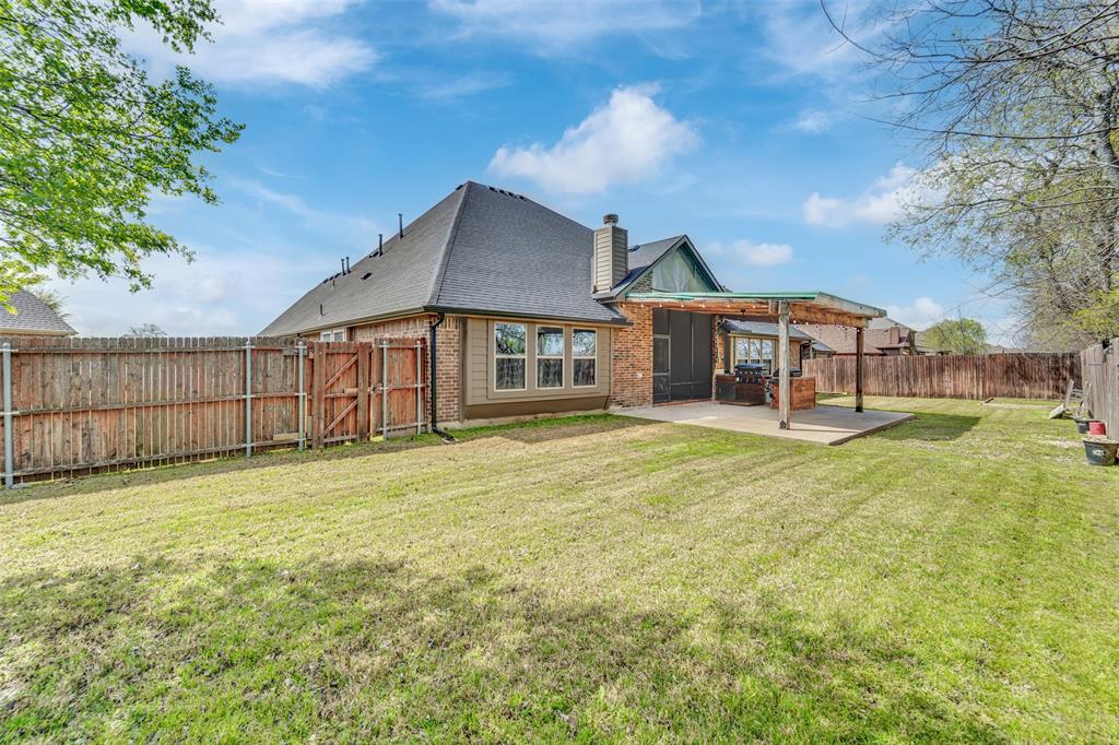 Backyard featuring a concrete patio with a covered pergola, brick and siding exterior, and wood privacy fencing
