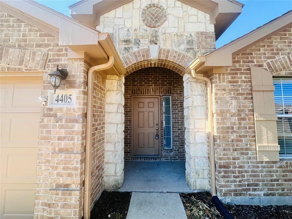 View of exterior entry with a garage