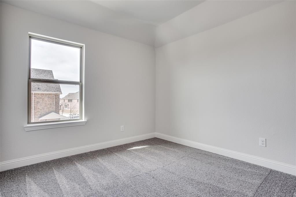 Neutral interior space featuring textured wall-to-wall carpeting, crisp white walls, and a single-hung window with a deep sill