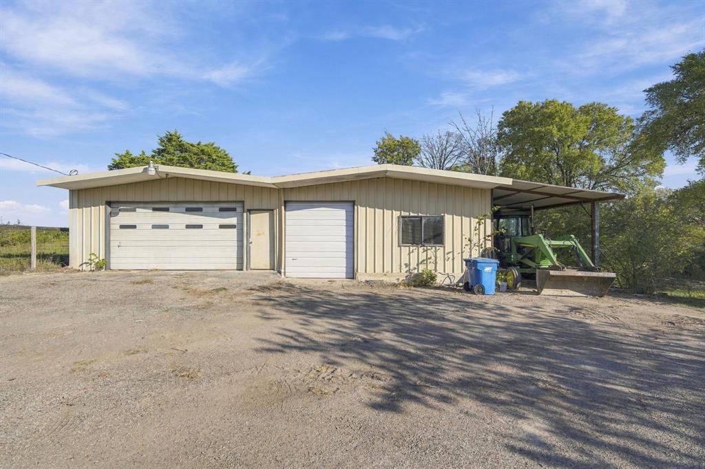 Workshop with electric.  RV parking where tractor is now parked