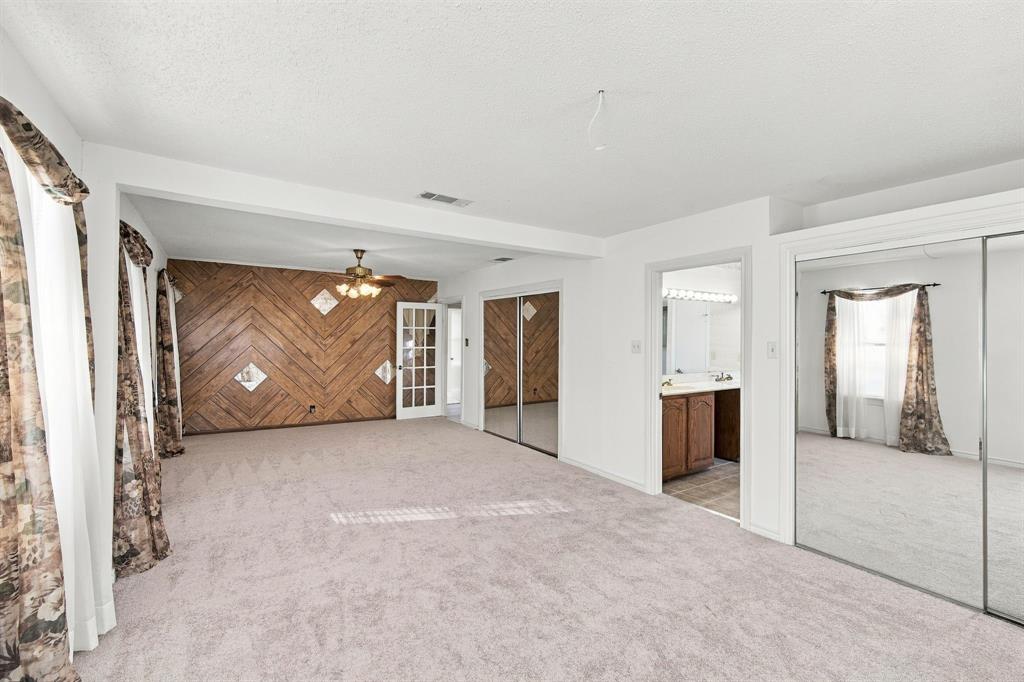 View to primary bath and door to hallway.  Two closets