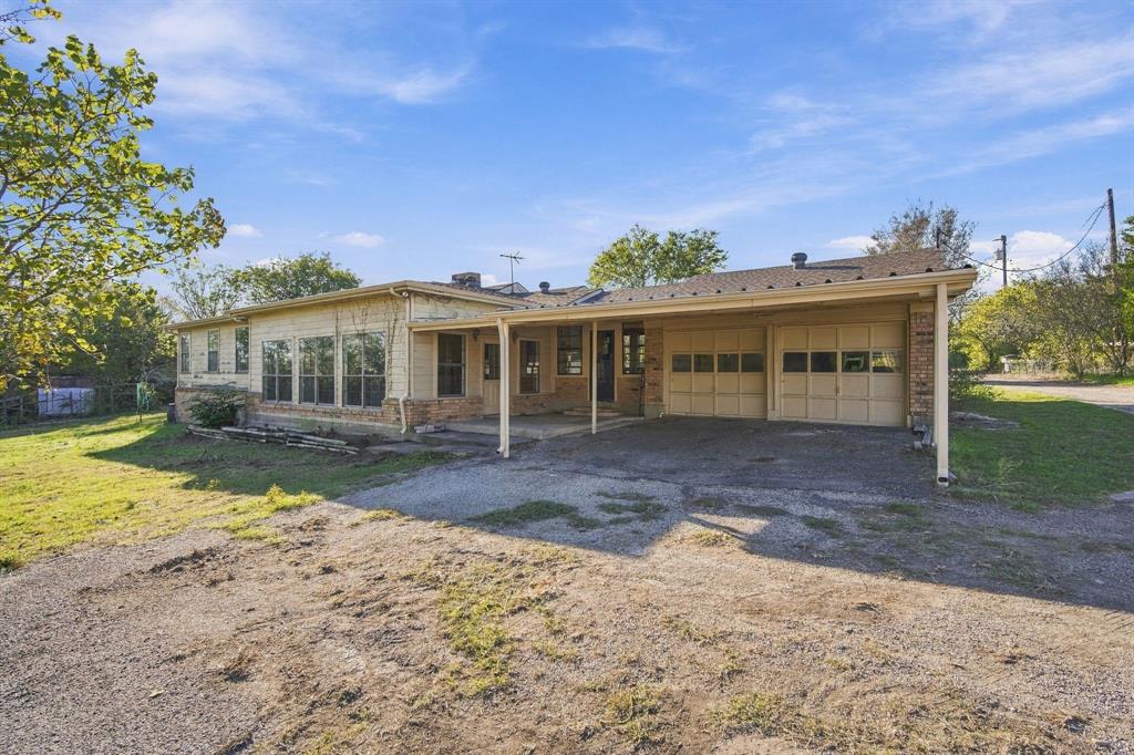Carport leading to garage and covered patio
