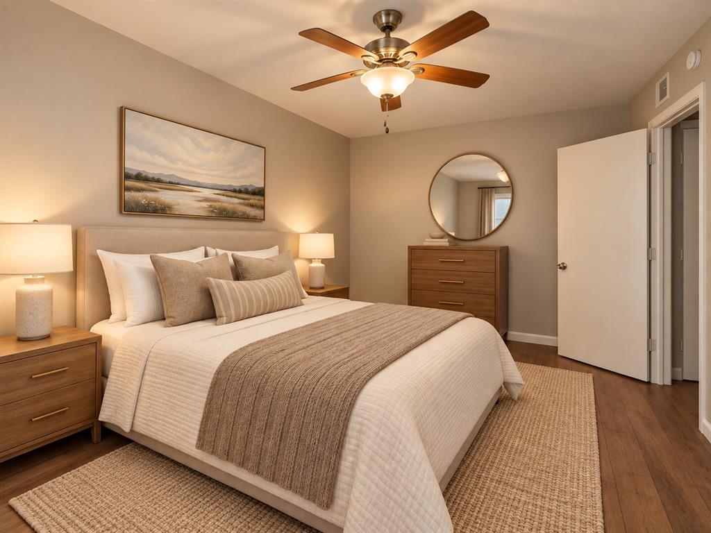 Wood-finish flooring, neutral wall tones, and ceiling fan with integrated lighting