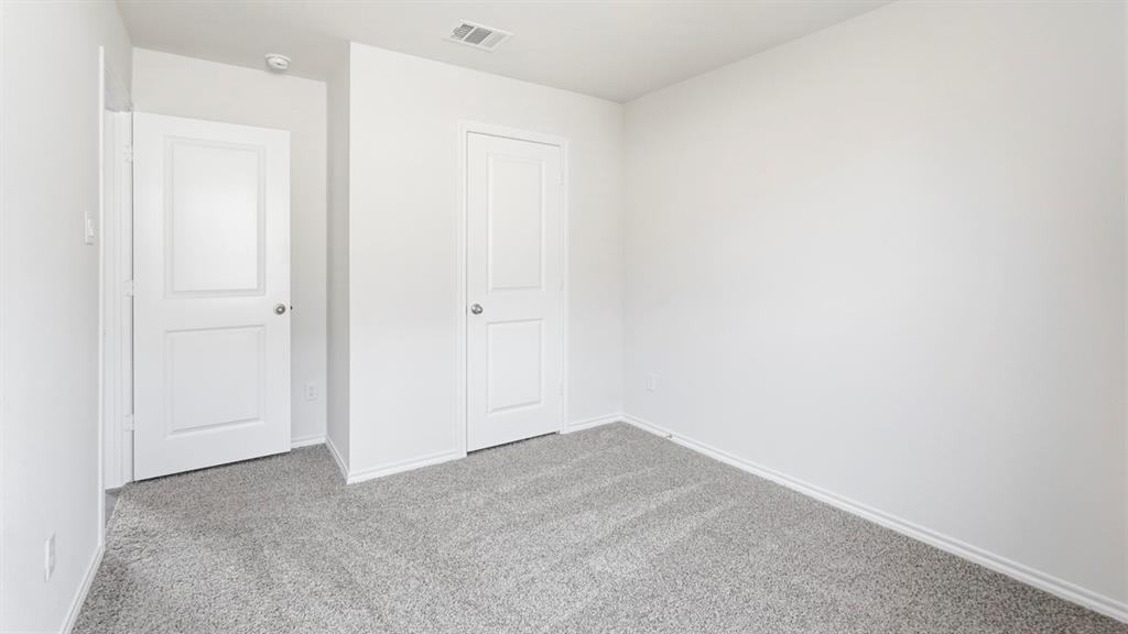Neutral wall finishes paired with plush gray carpeting