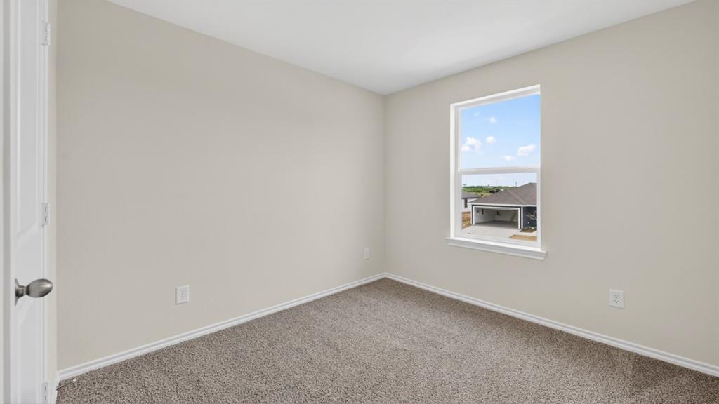 Neutral-toned room featuring a single window, light gray walls, and carpet flooring