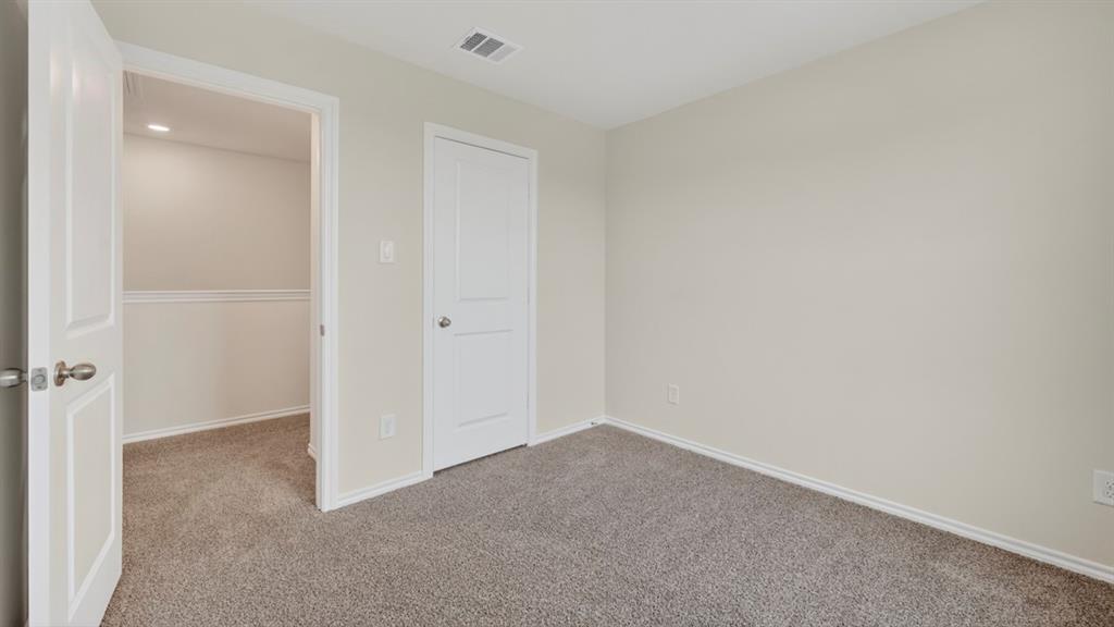 Neutral-toned room with plush carpeting and light-colored walls