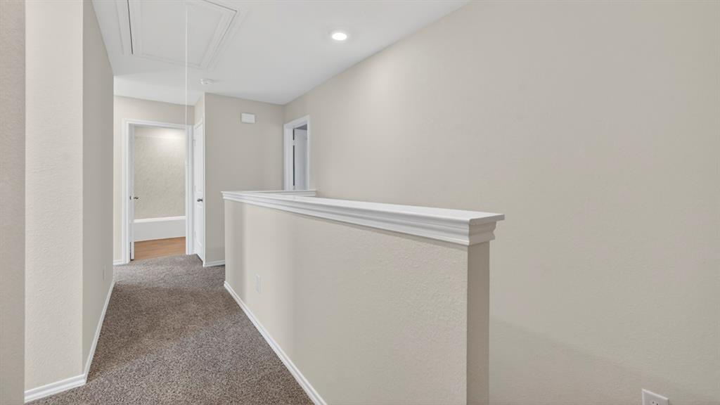 Neutral-toned interior hall with plush gray carpeting