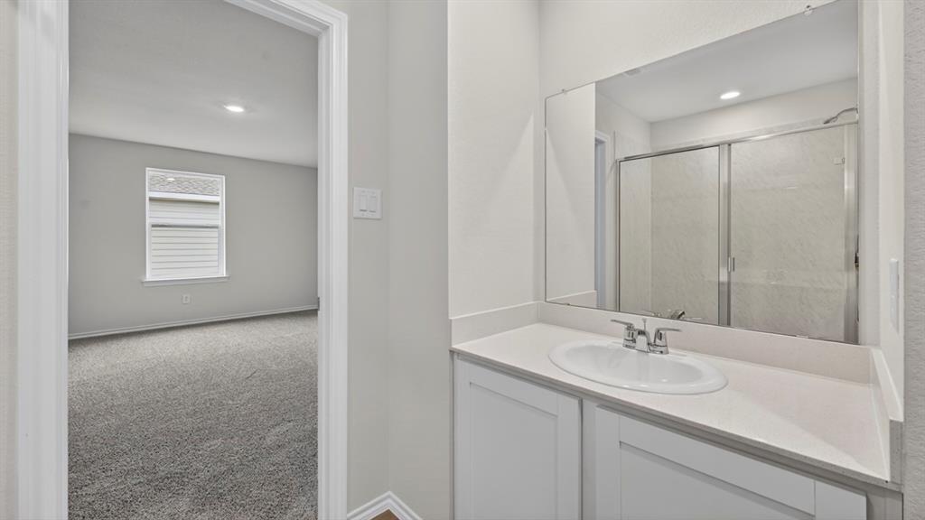 Contemporary bathroom vanity with an integrated sink, polished chrome faucet, and expansive wall-mounted mirror