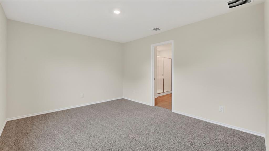 Recessed lighting, light-toned walls, and grey carpeting