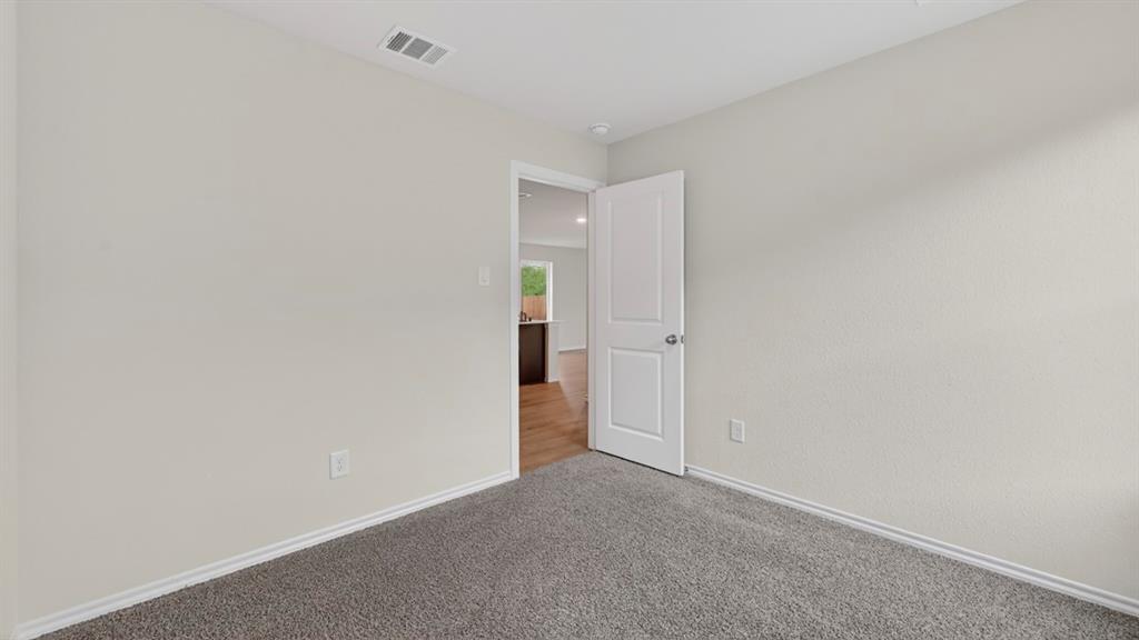 Neutral wall color, wall-to-wall carpeting, white interior door, recessed lighting