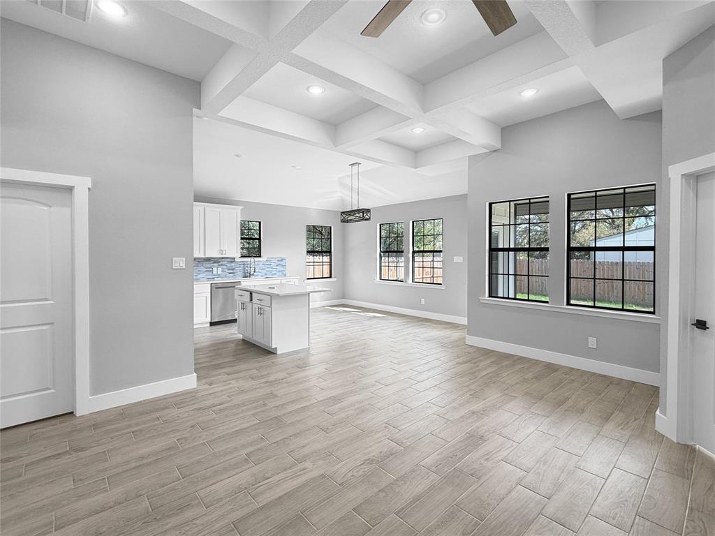 Coffered ceiling with recessed lighting, wood-finish tile flooring, and windows with black frames Coffered ceiling with recessed lighting, wood-finish tile flooring, and windows with black frames
