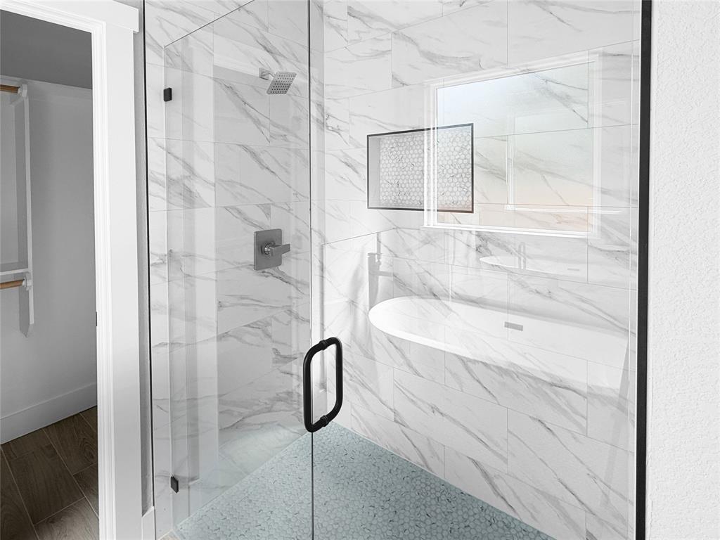 Walk-in shower featuring glass enclosure, large-format tiled walls with stone-pattern finish, pebble-texture flooring, integrated tiled niche, and matte black fixtures Walk-in shower featuring glass enclosure, large-format tiled walls with stone-pattern finish, pebble-texture flooring, integrated tiled niche, and matte black fixtures