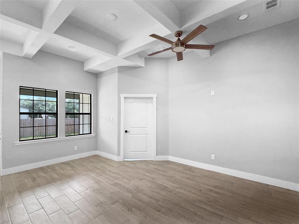 Coffered ceilings featuring recessed lighting, wood-finish flooring, and black-framed windows