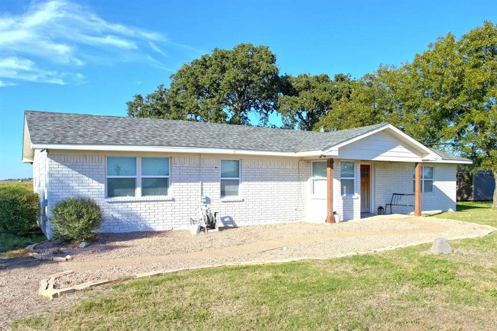 Single-story Ranch-Style, brick exterior featuring a covered front porch, asphalt shingle roof, and decorative wooden support posts Single-story Ranch-Style, brick exterior featuring a covered front porch, asphalt shingle roof, and decorative wooden support posts