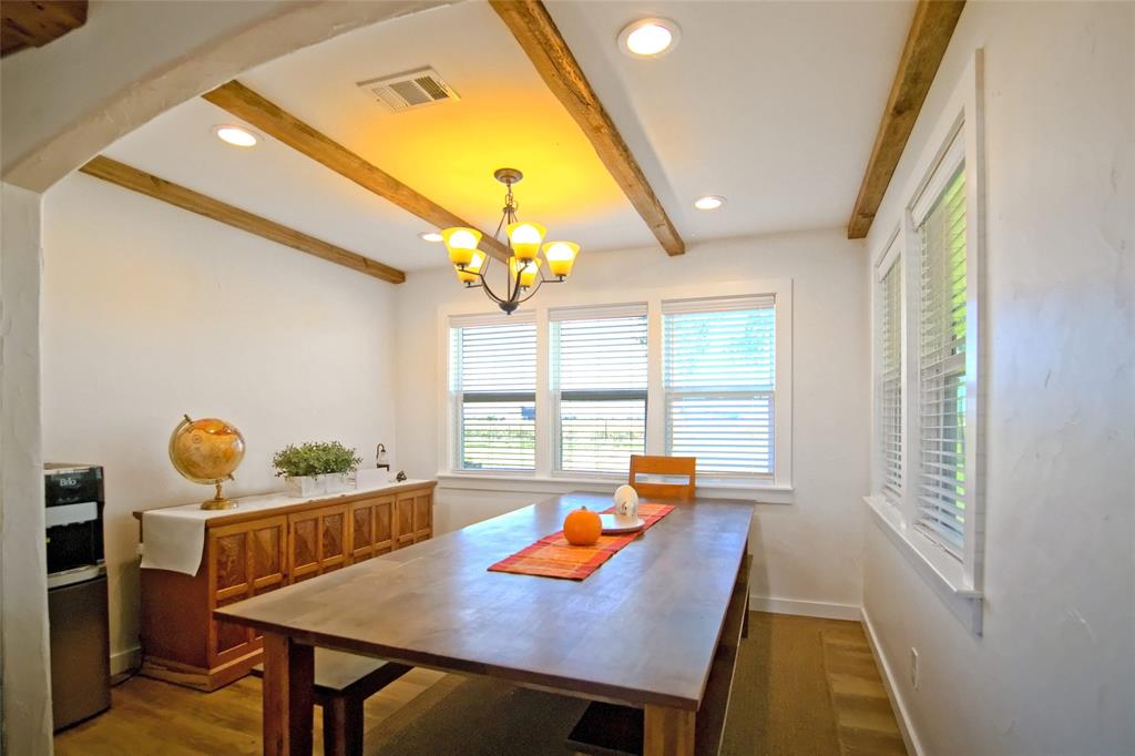 Exposed wood ceiling beams, recessed lighting, multi-pane windows, and wood-finish flooring