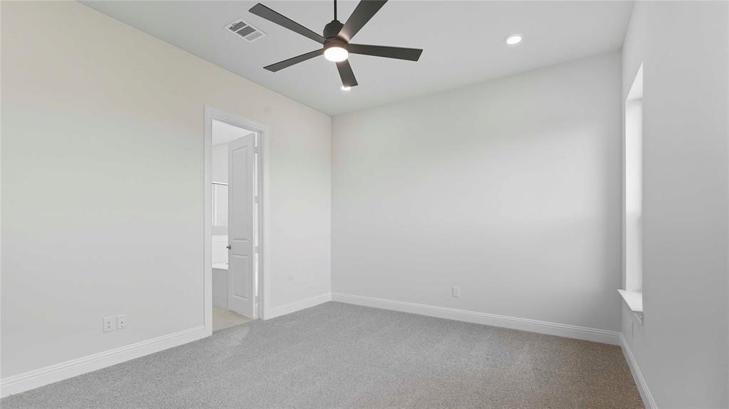 Neutral-toned carpeting, high ceilings, ceiling fan with integrated lighting, recessed lighting, and a solid-core interior door
