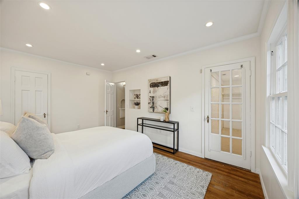 Hardwood flooring, recessed lighting, built-in wall niche, and French door with glass panes