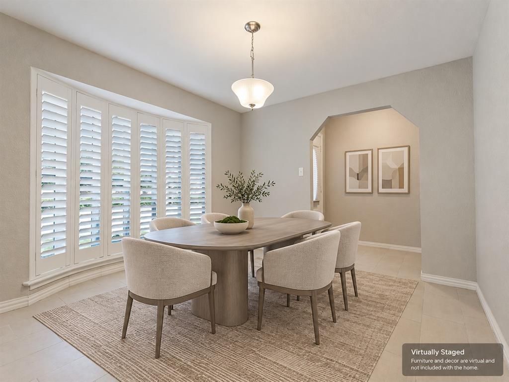 Bay window with plantation shutters, neutral tile flooring, and a glass pendant light fixture