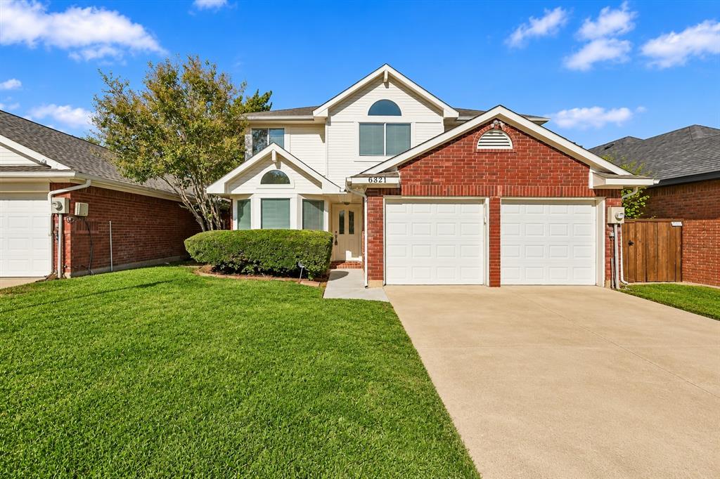 Two-story residence featuring a brick and siding exterior, a concrete driveway, a double-car garage, and a front-facing bay window