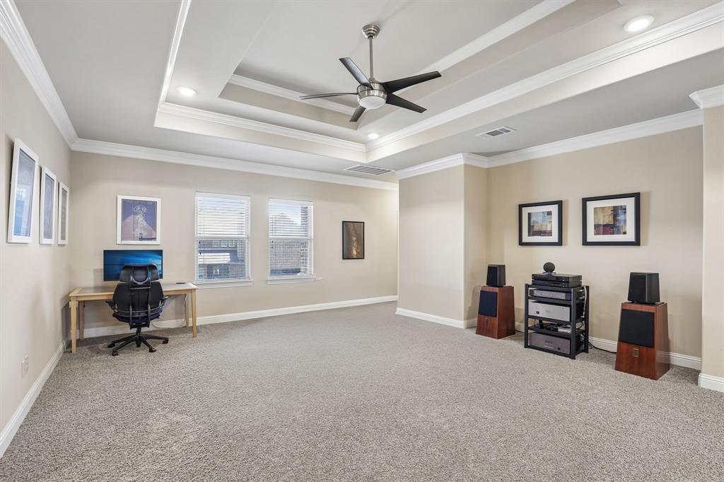 Second floor living room featuring tray ceiling featuring crown molding and a center-mounted ceiling fan with integrated lighting, recessed lighting, and carpeted flooring