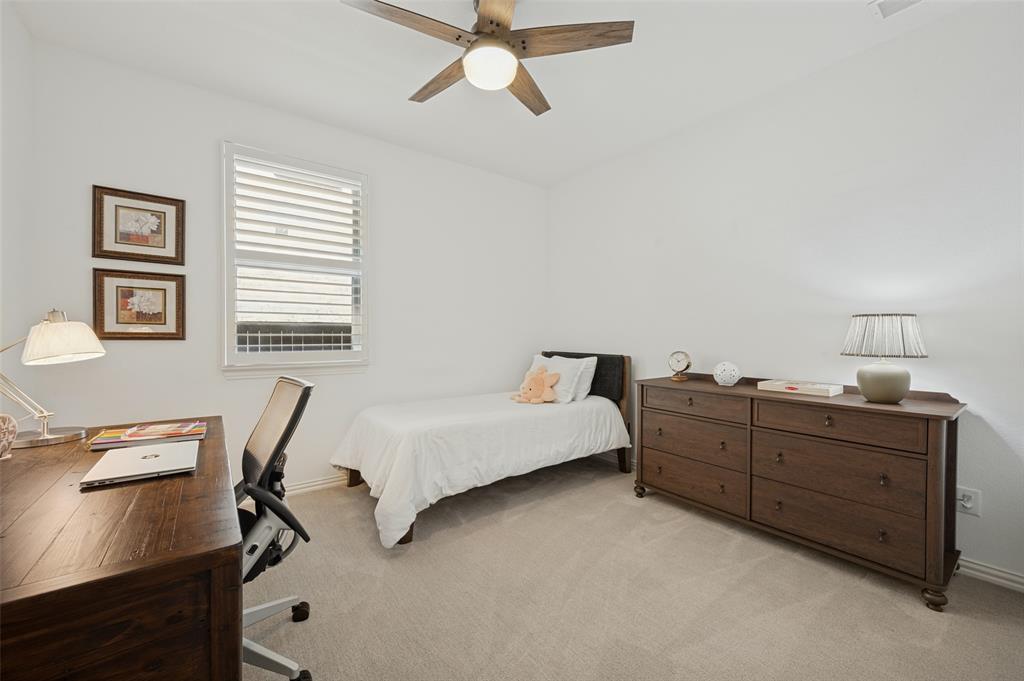 Neutral carpeting, white interior paint, ceiling fan with light kit, and plantation shutter window coverings