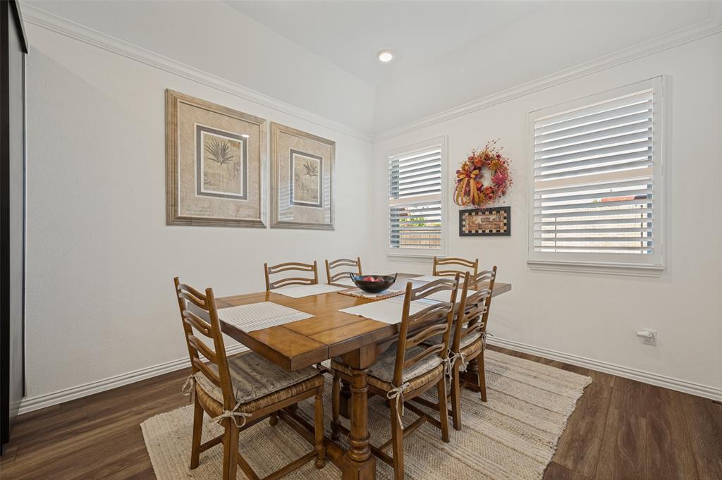 Tray ceiling, wood-finish flooring, and white plantation shutters