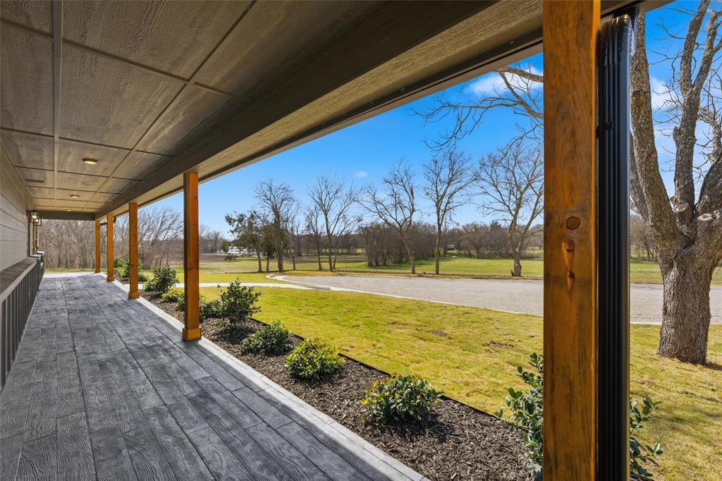 Covered porch featuring wood-finish floor planks, timber support posts, recessed lighting, and metal downspouts Covered porch featuring wood-finish floor planks, timber support posts, recessed lighting, and metal downspouts