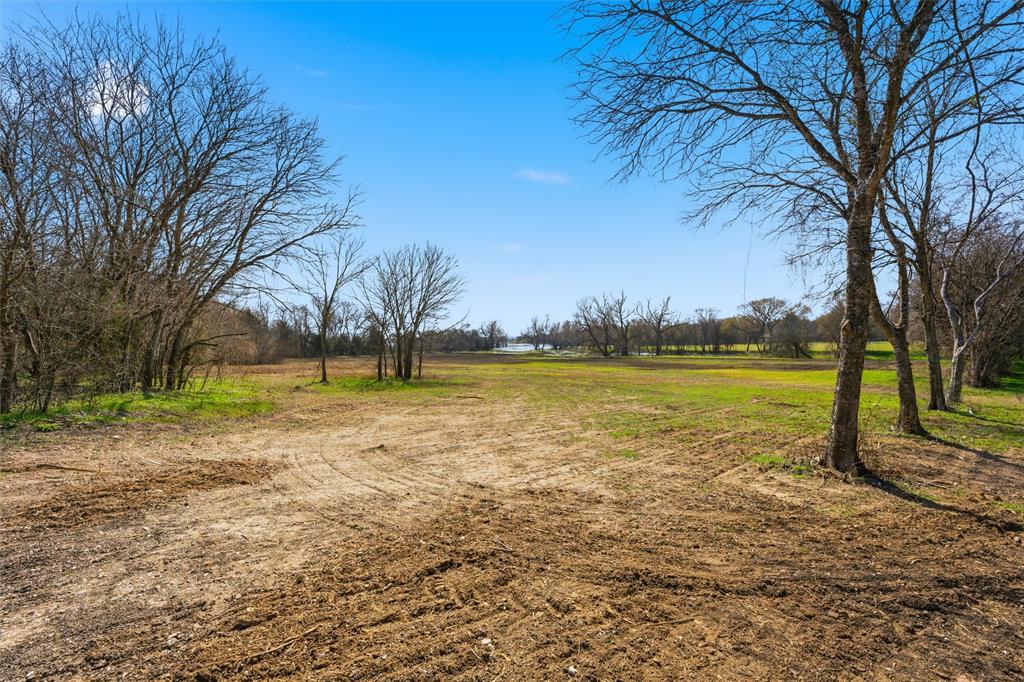 Expansive level lot featuring cleared acreage and mature trees