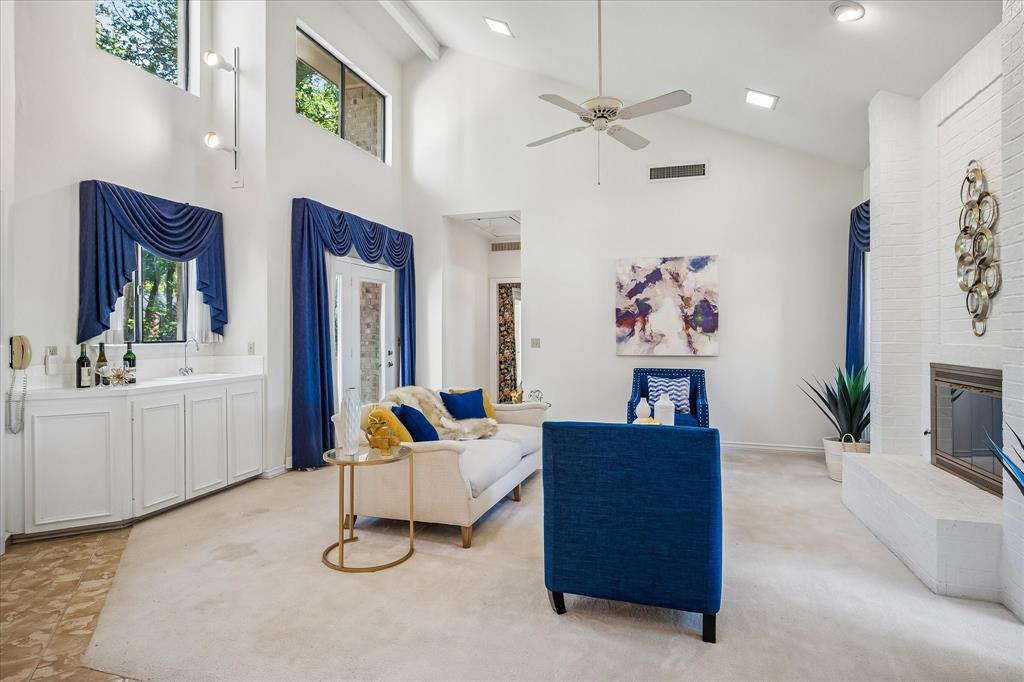 The living room is spacious with a 2 story cathedral ceiling with plenty of natural light and a gas log burning fireplace with a wet bar.