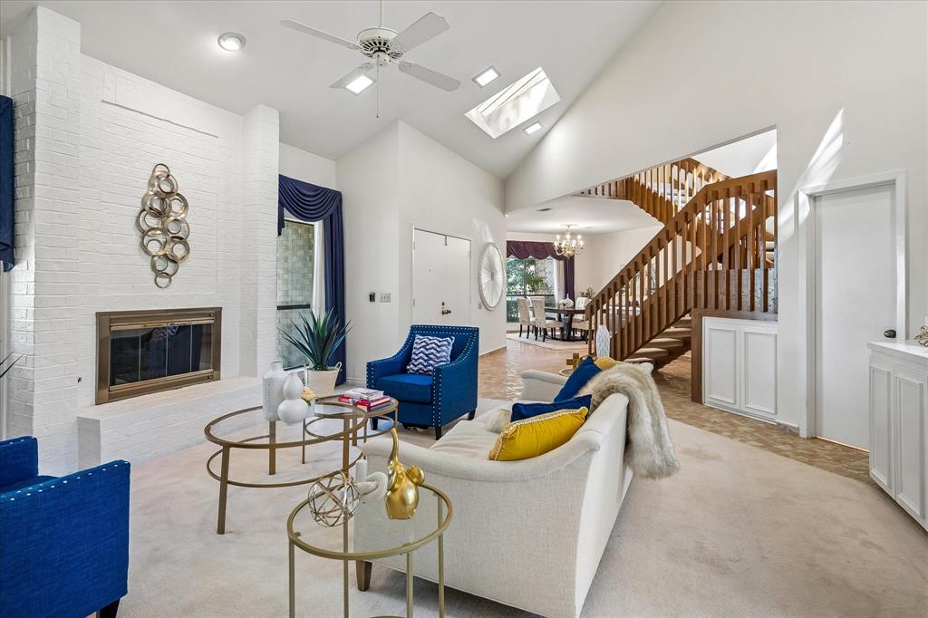 Yet another view of the living room looking across the entry way into the dining room of the home. Notice the skylight capturing the natural light into the home.