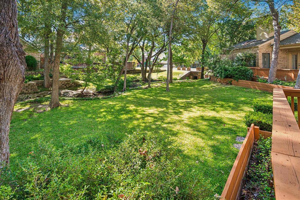 Yet another view of the large grassed backyard showing the creek running the length of the yard.