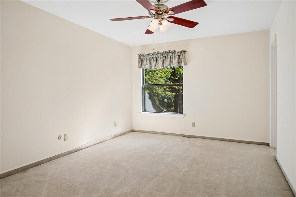 Bedroom #3 upstairs has views of the backyard creek lot thru the window and a nice size closet and a ceiling fan.