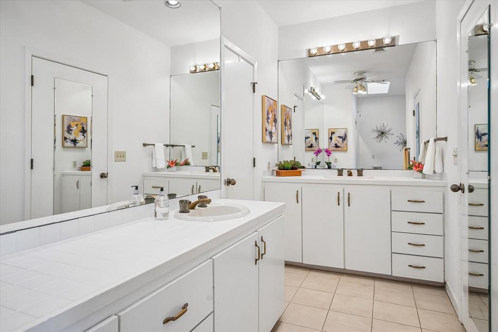 Primary bathroom has dual sink vanities with lots of counterspace and plenty of storage.