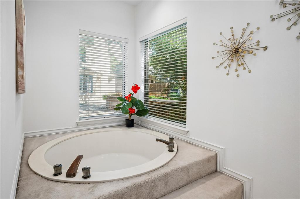 Primary bathroom has a large garden tub and a separate shower.