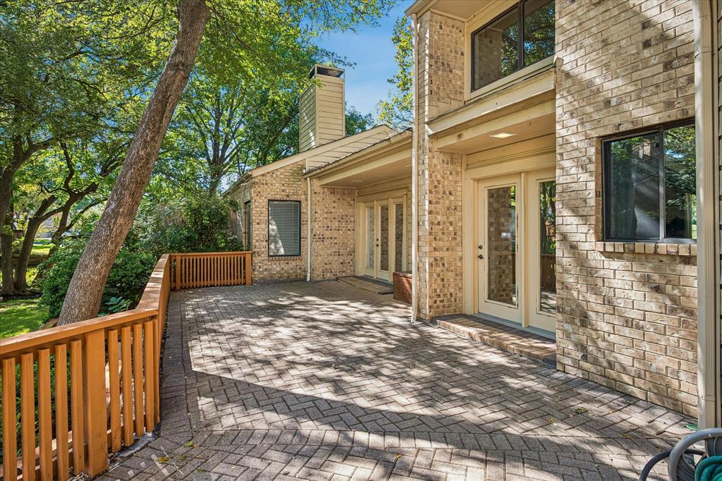 A view of the spacious paved deck looking out into the backyard.