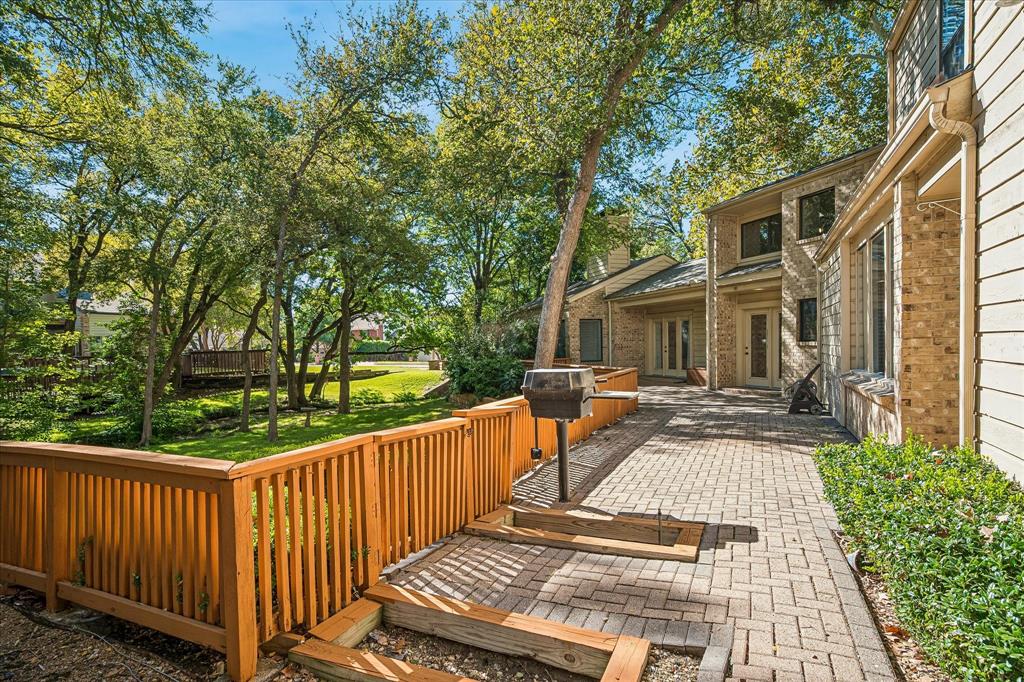 Another view of the backyard paved deck with a built-in gas grill.  Plenty of space to entertain and enjoy nature and wildlife from your backyard.