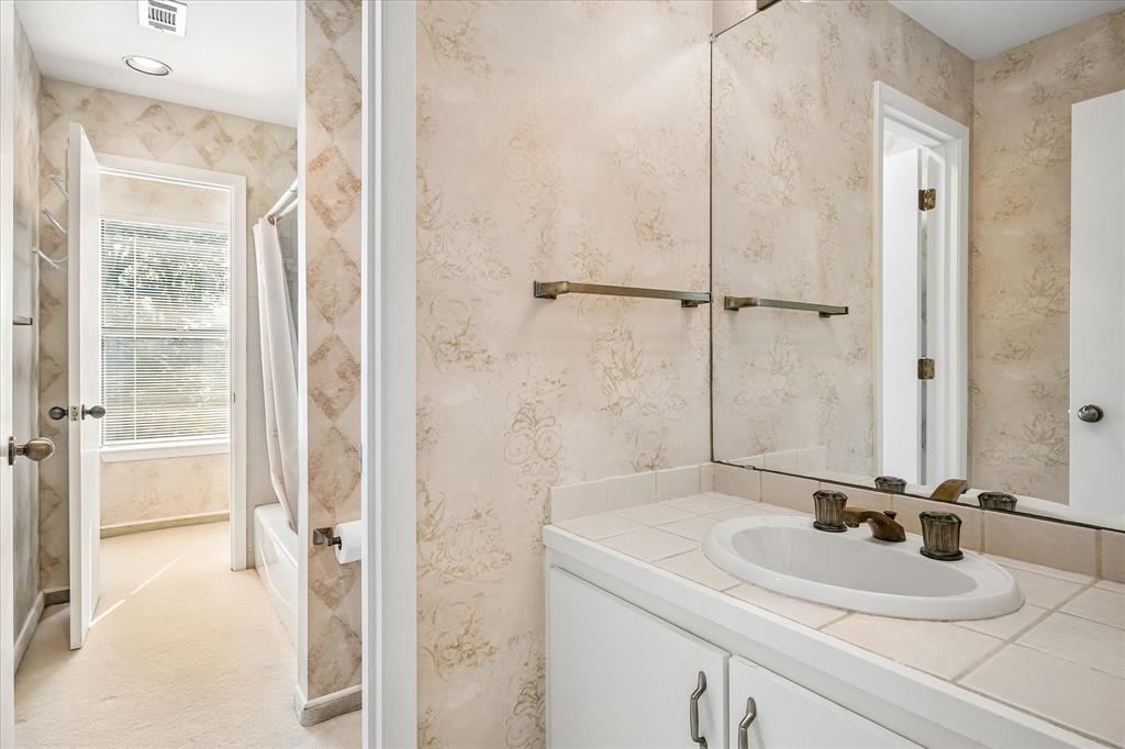 The full bath serving the bedrooms upstairs has dual vanities and a tub/shower combo.