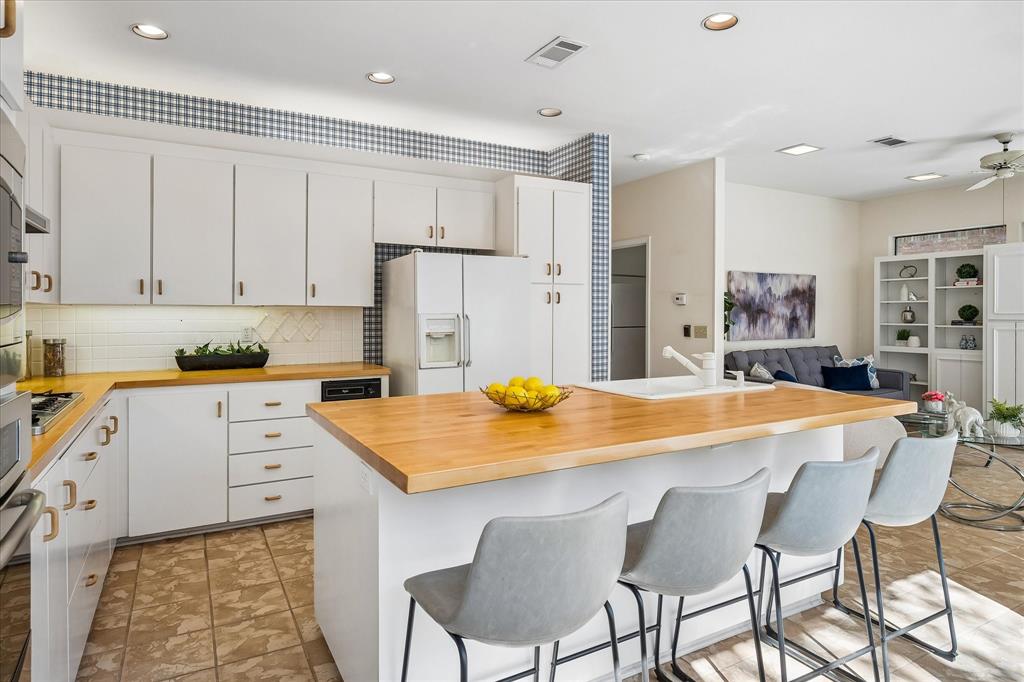 Yet another view of the kitchen area with a gas stovetop and a built-in microwave and convection oven.