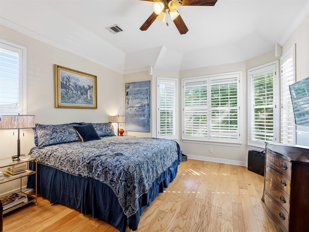 Trey ceiling, wood-finish flooring, bay window configuration, and plantation shutters