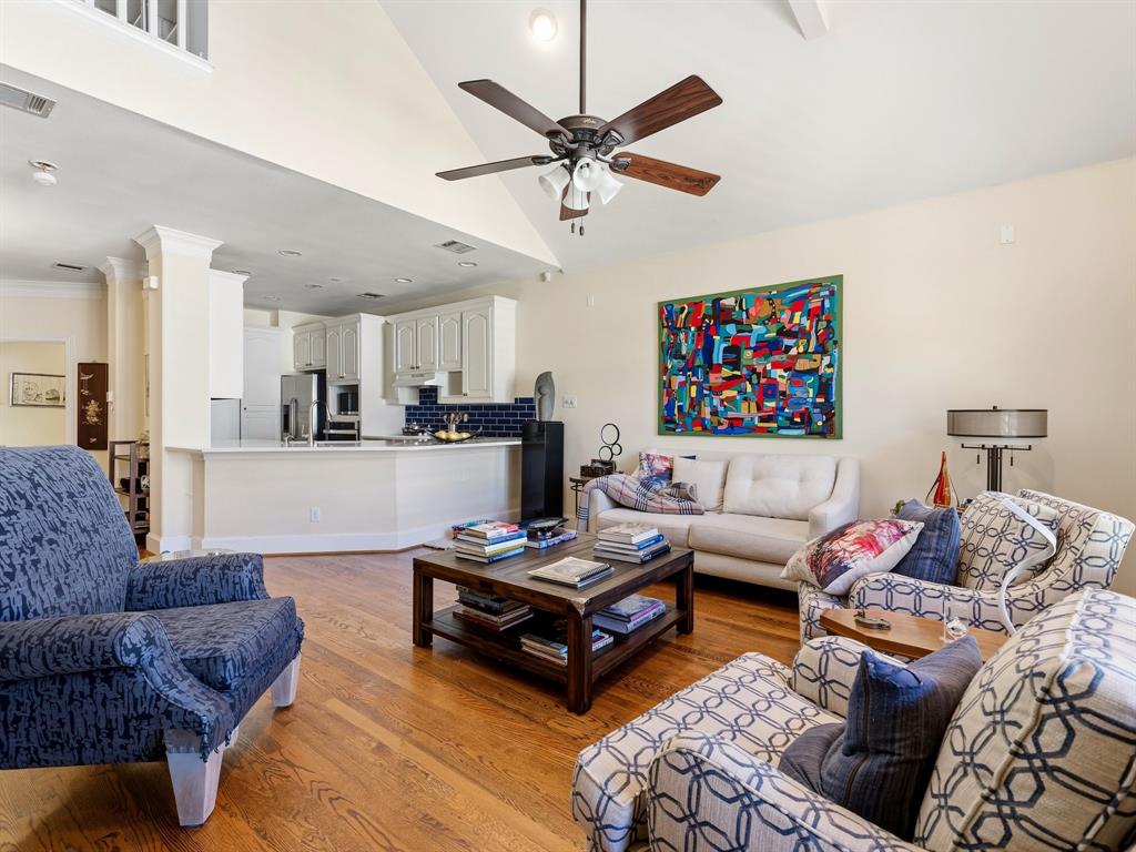 Vaulted ceilings with recessed lighting, wood-finish flooring, ceiling fan, and kitchen featuring cabinetry and a subway tile backsplash Vaulted ceilings with recessed lighting, wood-finish flooring, ceiling fan, and kitchen featuring cabinetry and a subway tile backsplash