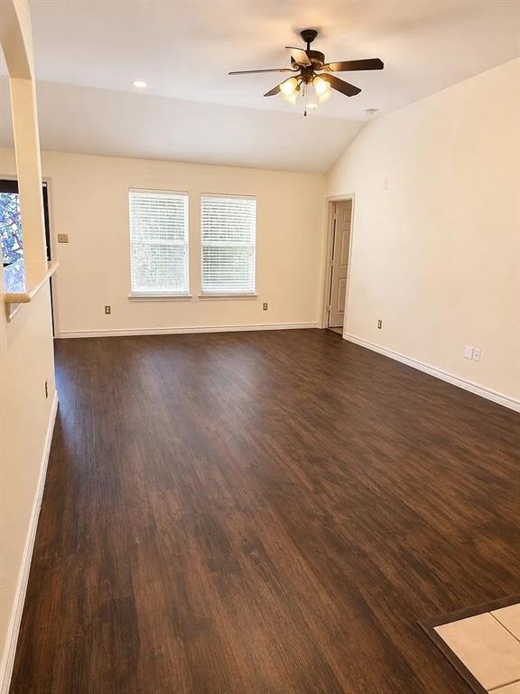 Vaulted ceilings, wood-finish flooring, dual windows, and a ceiling fan with integrated lighting