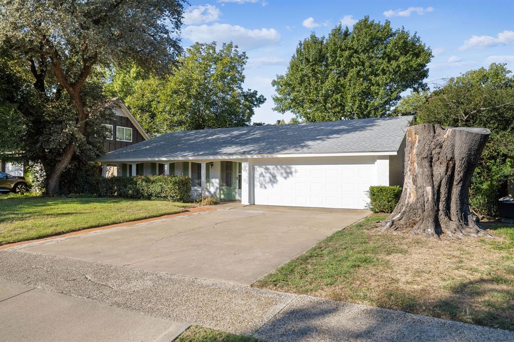 Single-story residence featuring a painted brick exterior, covered front porch, and an attached two-car garage Single-story residence featuring a painted brick exterior, covered front porch, and an attached two-car garage