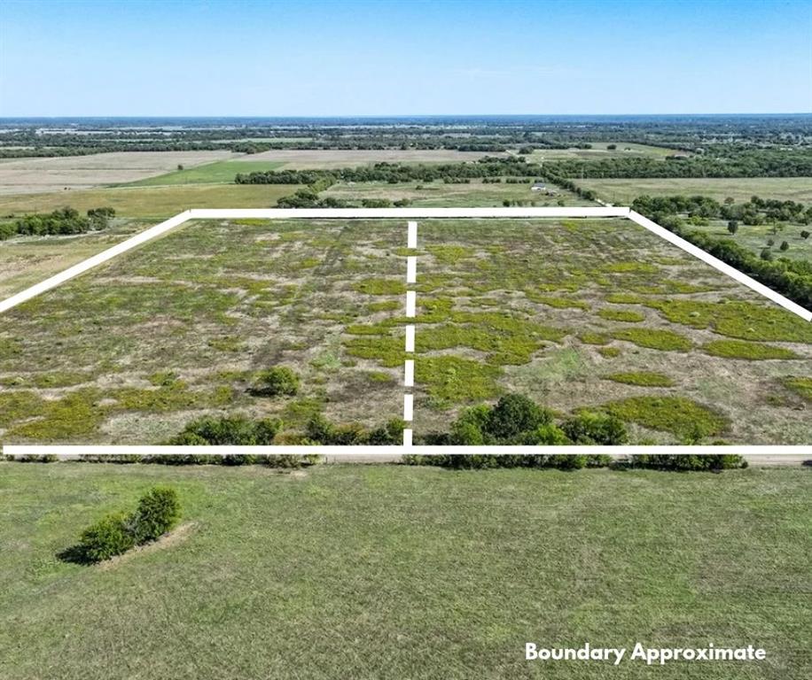 Expansive acreage featuring level topography, open pastureland, and established perimeter vegetation