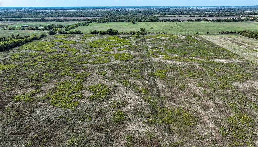 Expansive acreage featuring open meadow terrain, native vegetation, and mature tree lines