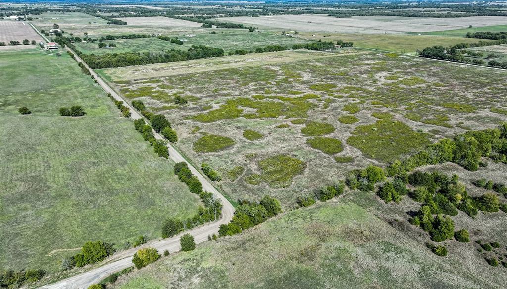 Expansive acreage featuring open meadow terrain, clusters of mature trees, and direct access to a paved thoroughfare Expansive acreage featuring open meadow terrain, clusters of mature trees, and direct access to a paved thoroughfare