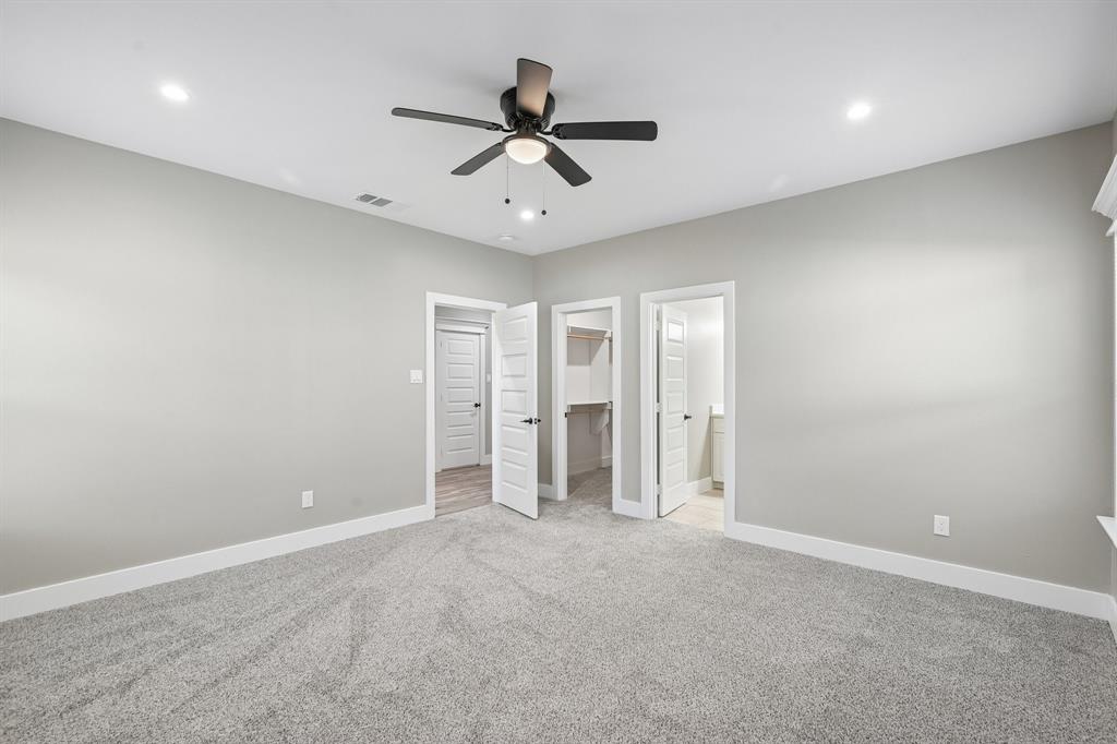 Neutral-toned interior featuring wall-to-wall carpeting, recessed ceiling lighting, and a multi-blade ceiling fan